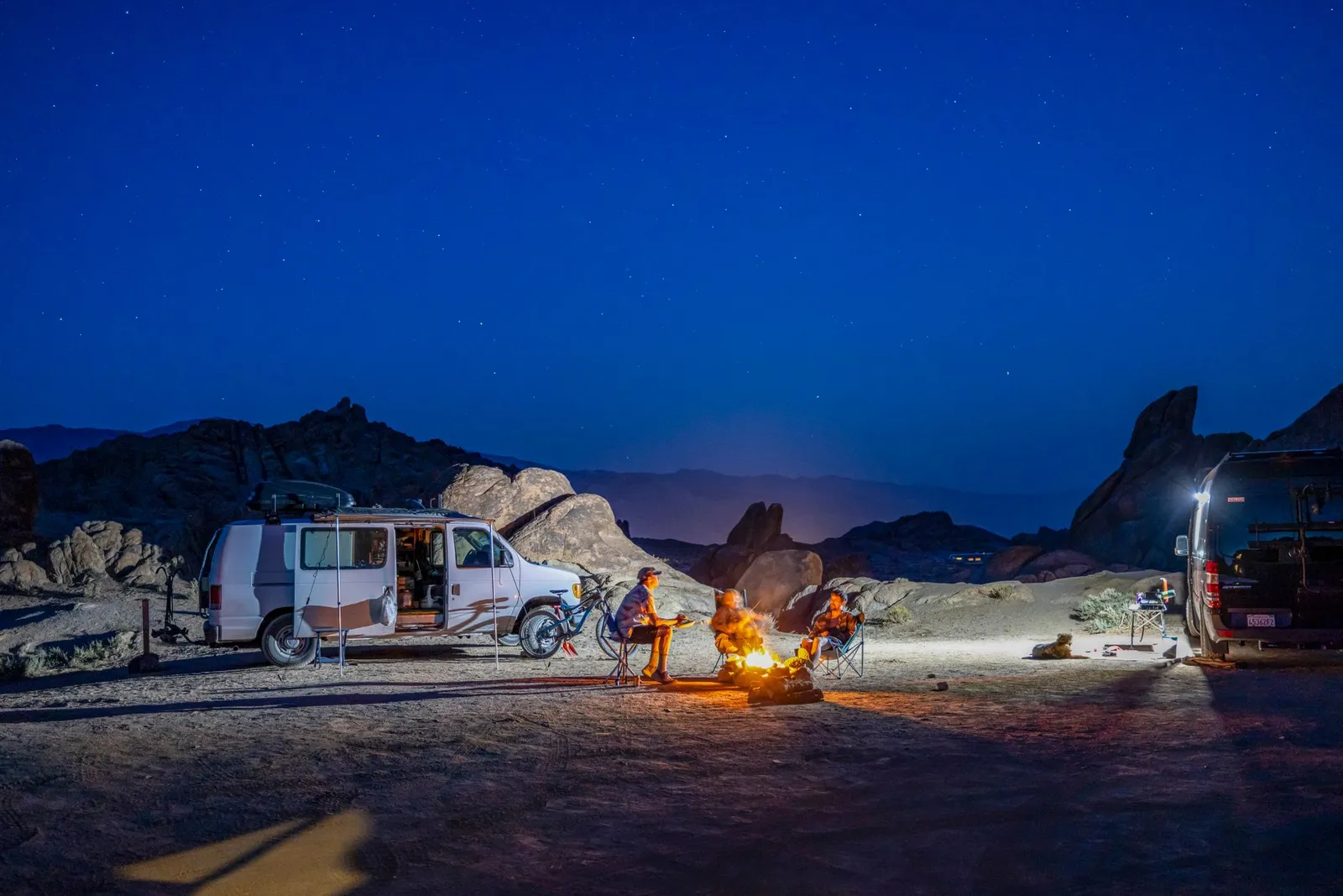 A well-equipped campsite at night: prioritize safety and hookup gear first, comfort second.