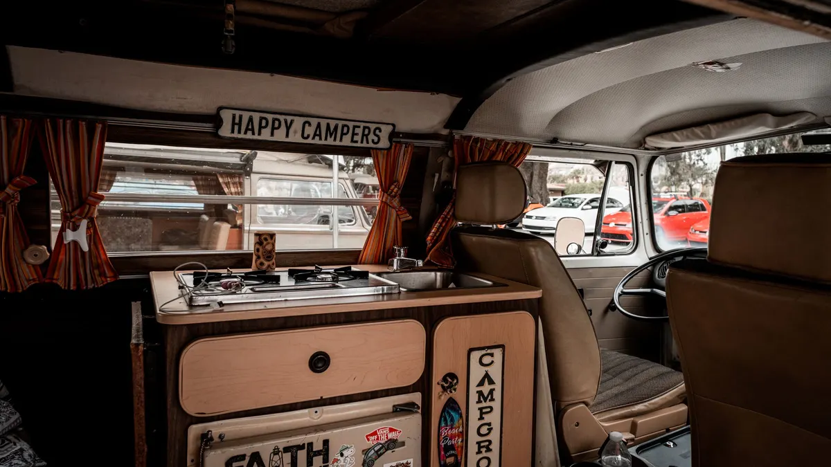 Vintage camper van interior with a small galley and sink