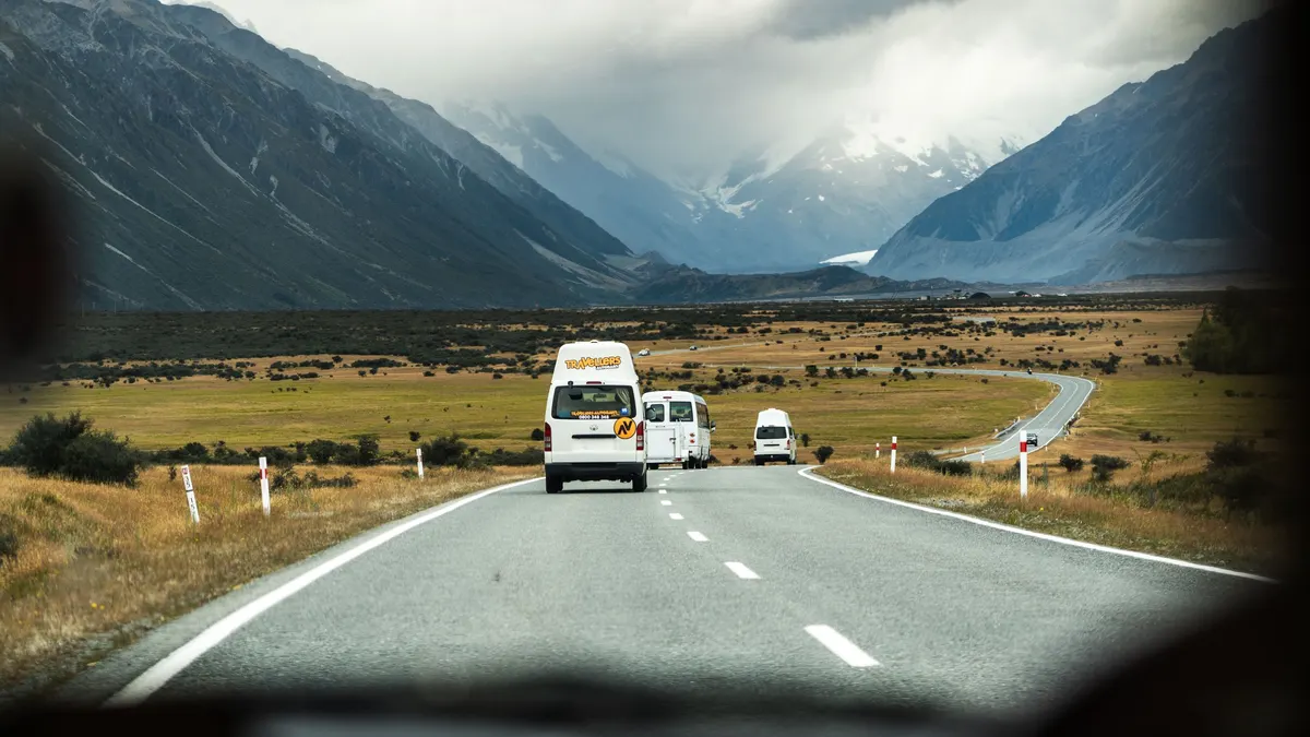 Motorhomes driving a highway through a mountain valley