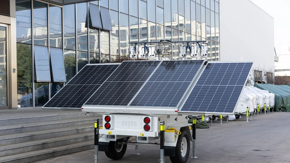 Trailer-mounted solar array with several panels angled toward the sky