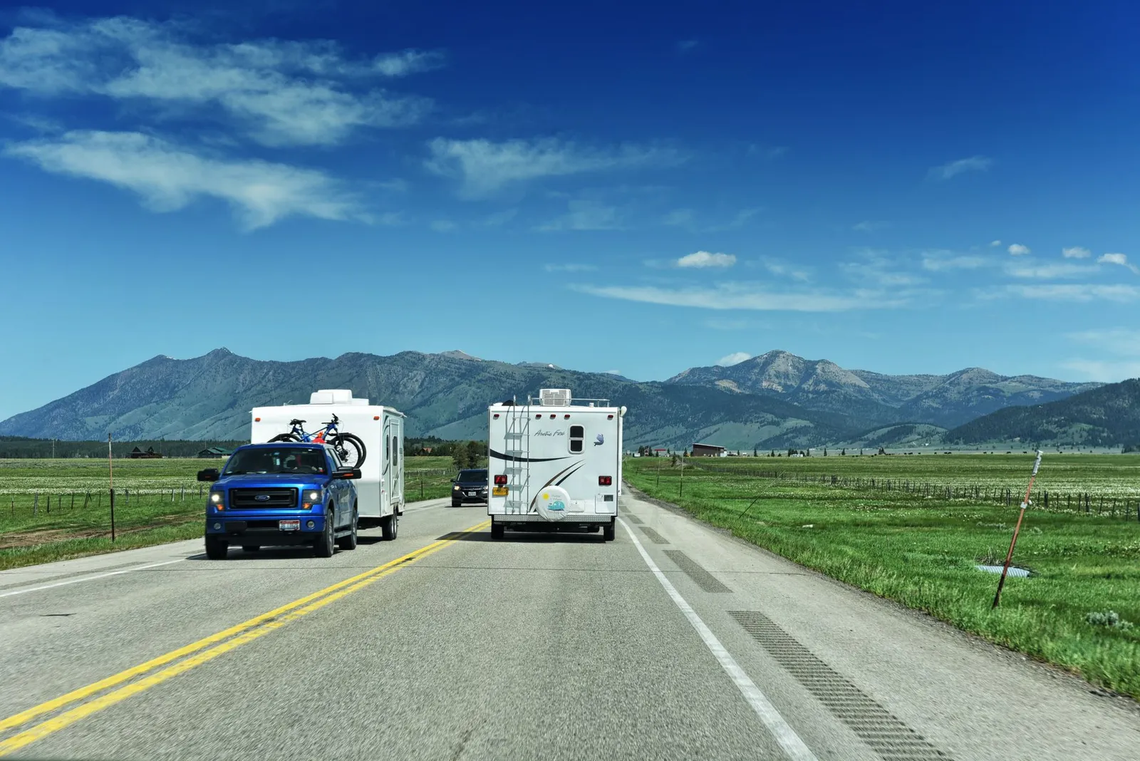 Open highway through a mountain valley: plan shorter drive days and arrive before dark.