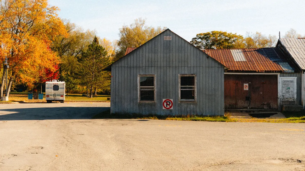 Metal storage building with autumn trees