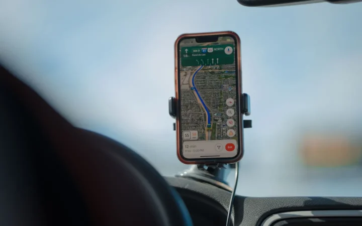 Phone showing a map in a dashboard mount while driving