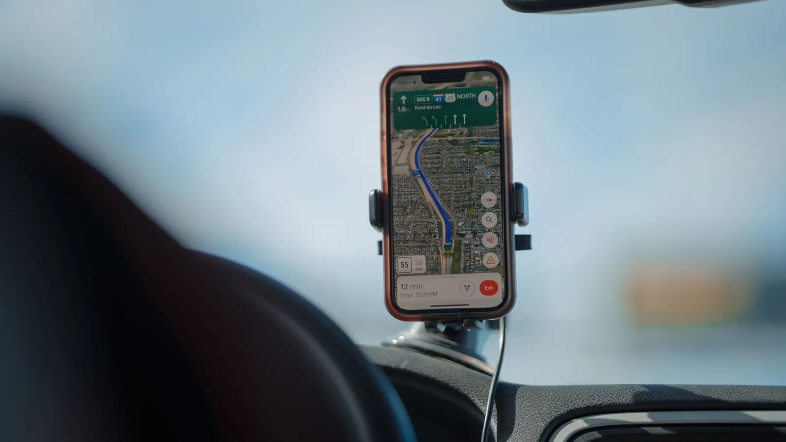 Phone showing a map in a dashboard mount while driving