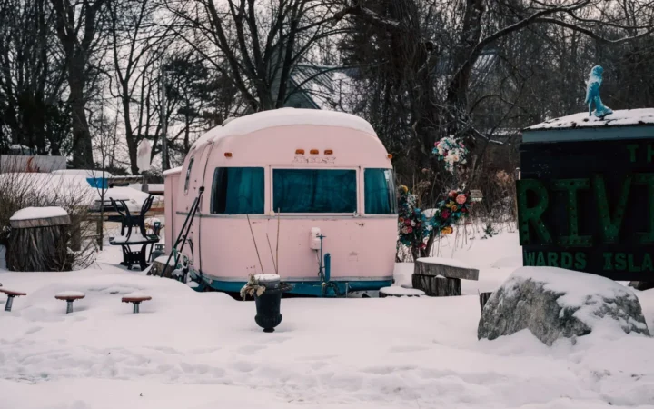 Vintage travel trailer surrounded by snow