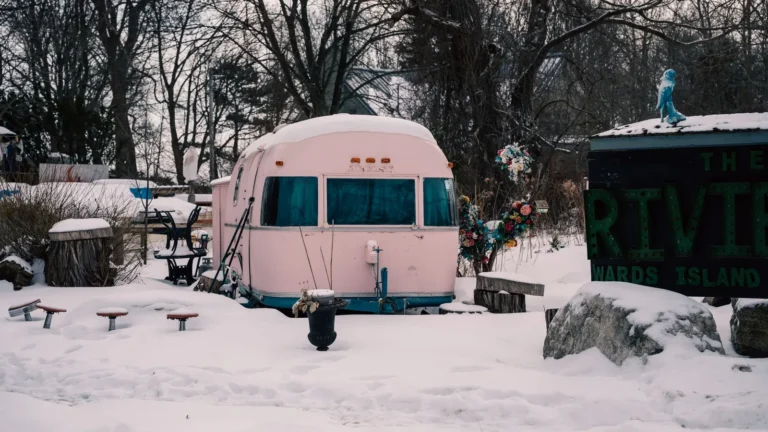 Vintage travel trailer surrounded by snow