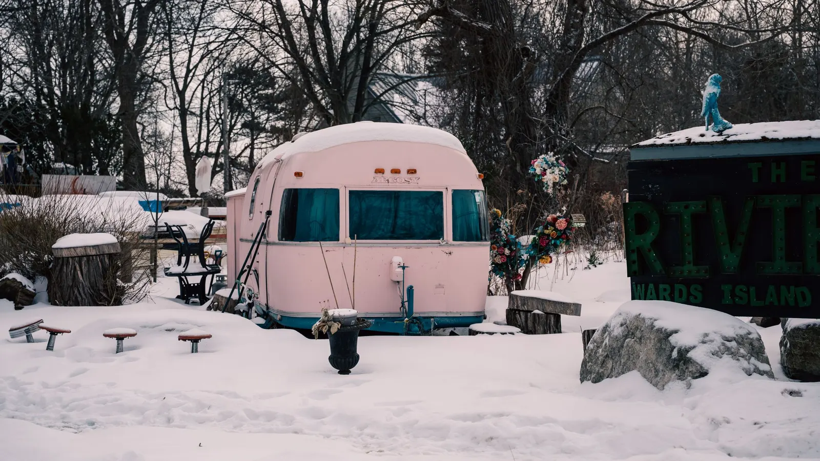 Vintage travel trailer surrounded by snow