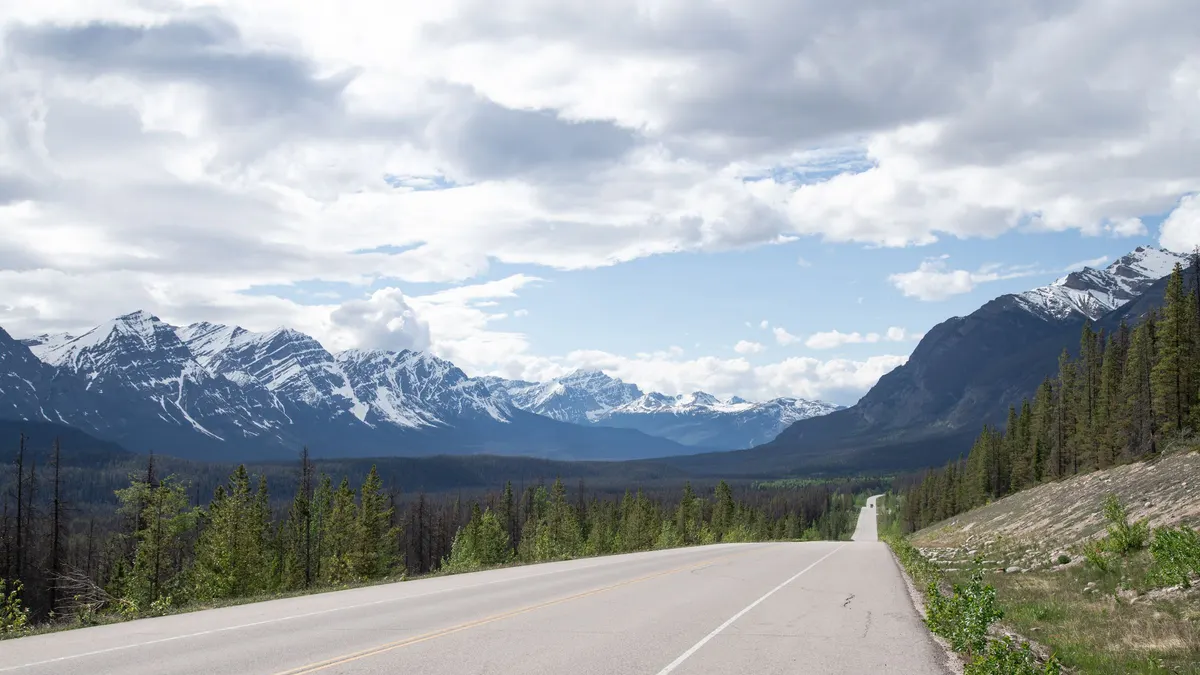 Highway leading toward snow-capped mountains