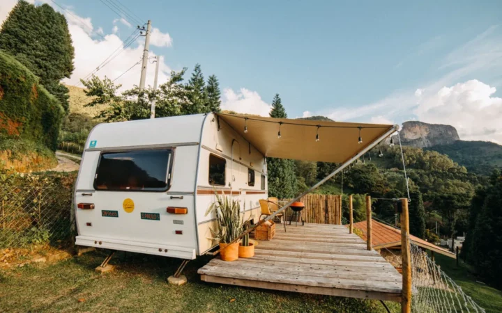 Travel trailer with an extended awning over a wooden deck