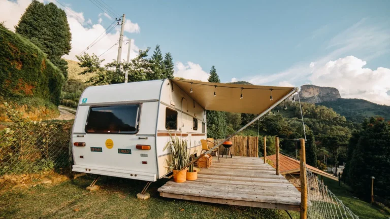 Travel trailer with an extended awning over a wooden deck
