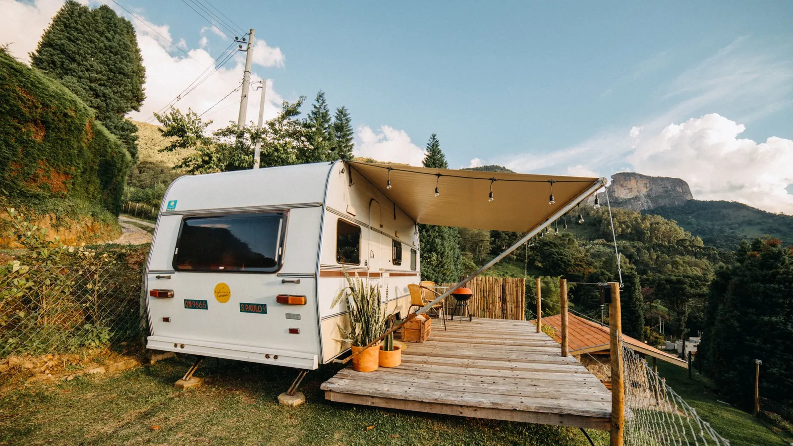 Travel trailer with an extended awning over a wooden deck