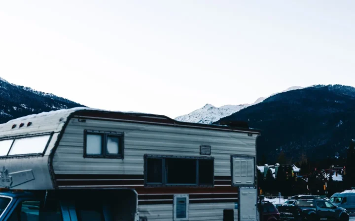 Travel trailer parked with snowy mountains behind