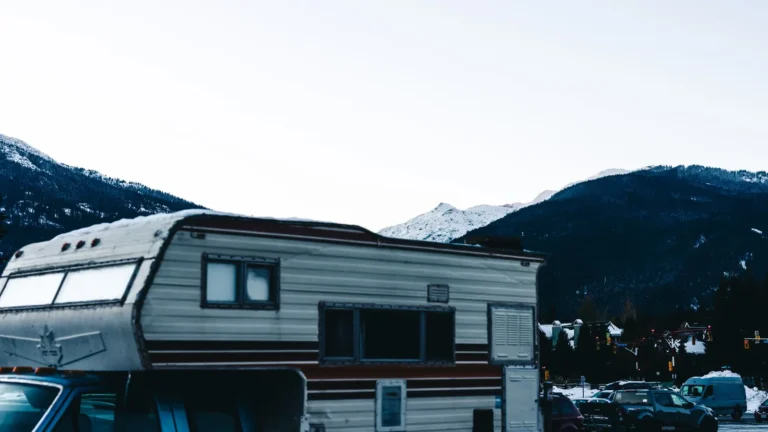 Travel trailer parked with snowy mountains behind