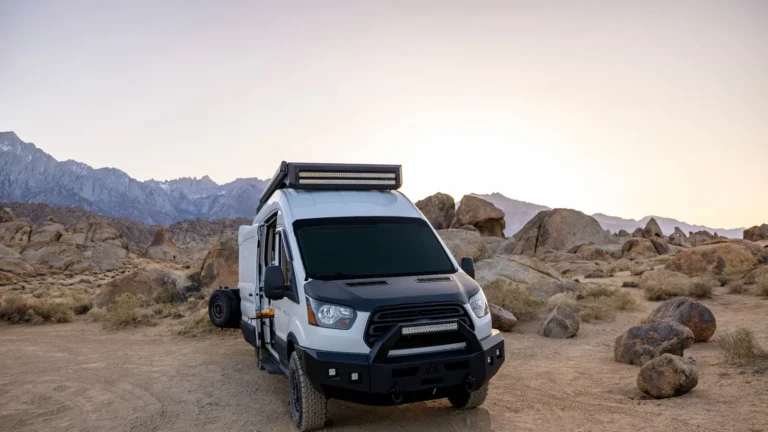 Camper van parked among desert boulders
