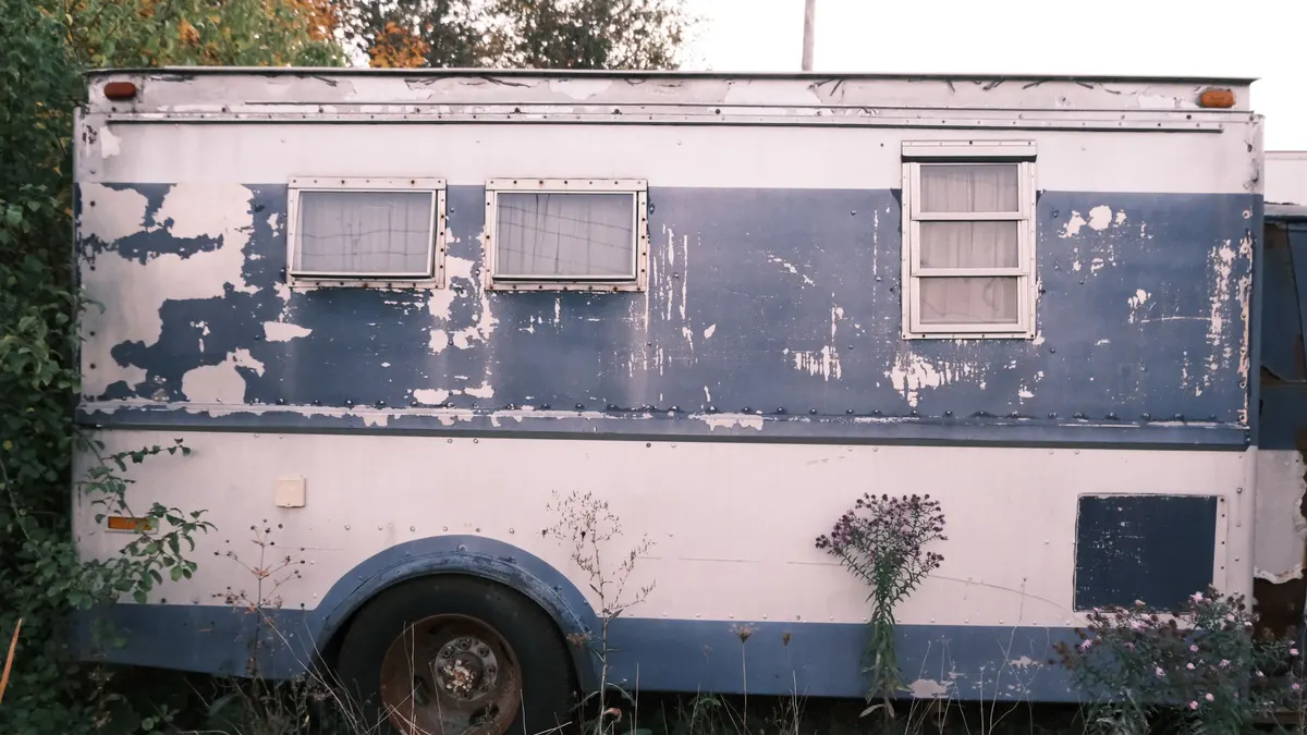 Weathered old camper with peeling exterior
